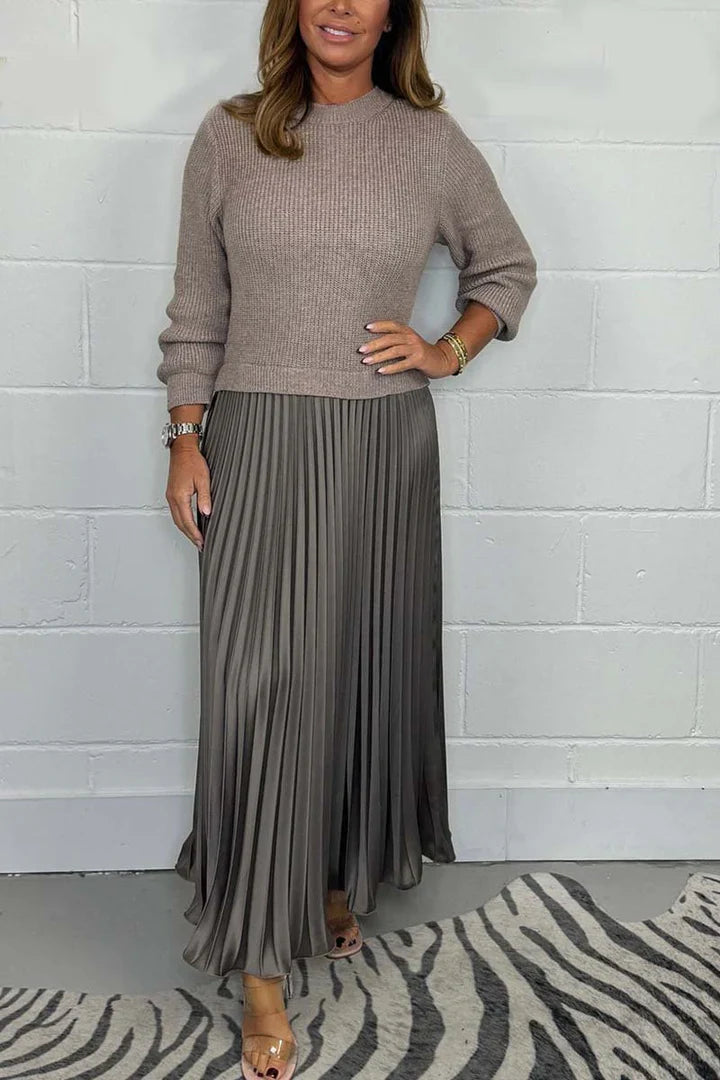 A high-quality women’s dress with a knitted top and a pleated skirt