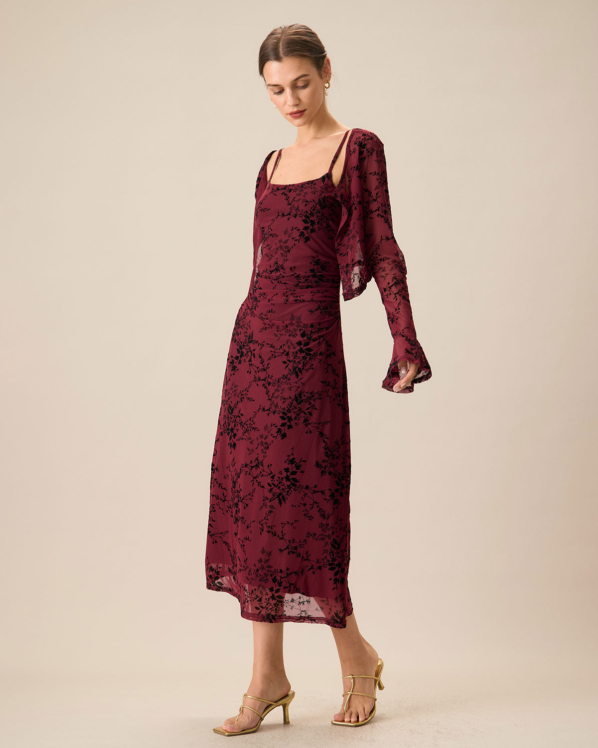 An elegant women’s fitted midi dress with straps and a floral pattern