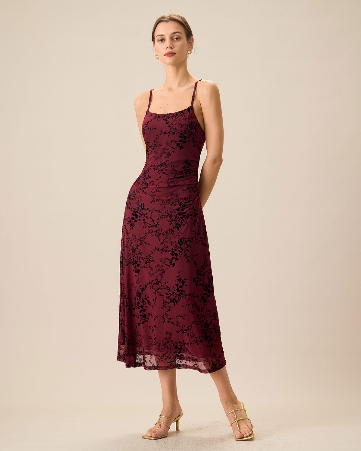 An elegant women’s fitted midi dress with straps and a floral pattern